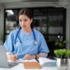 A,Professional,And,Focused,Asian,Female,Doctor,In,Scrubs,Is