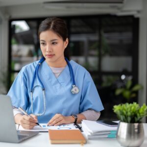 A,Professional,And,Focused,Asian,Female,Doctor,In,Scrubs,Is